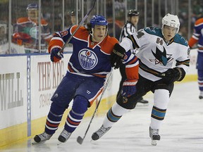 The Oilers Ryan Jones and Sharks forward Jamie McGinn chase a lose puck during their game Nov. 27, 2010, at Rexall Place. (PERRY NELSON/SUN FILE)