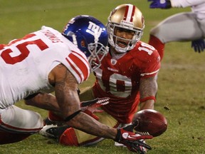 New York Giants wide receiver Devin Thomas (L) recovers a fumble by San Francisco 49ers wide receiver Kyle Williams (R) during overtime in the NFL's NFC Championship game in San Francisco January 22, 2012. REUTERS/Jeff Haynes