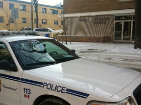 A police cruiser sits near an Assiniboine Avenue apartment block, where a woman was killed Monday, Jan. 23, 2012. Police are investigating the death as a homicide. (TAMARA KING/Winnipeg Sun)