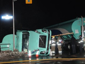 A fuel tanker lies partially on its side after flipping into ditch at Leitrim and Hawthorne roads Monday night. The roads were closed overnight while the scene was cleaned up. (Ottawa Fire Department photo)