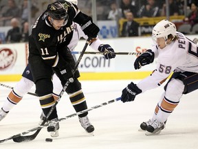 Center Aaron Gagnon of the Dallas Stars skates the puck against Jeff Petry of the Edmonton Oilers at American Airlines Center on January 26, 2011 in Dallas, Texas. (AFP-Getty Images)
