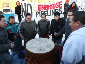 Traditional drummers Thundering Spirit from the Enoch Cree Nation take part in a protest outside the start of the Enbridge Northern Gateway Project review hearings in Edmonton at the Wingate Inn, 18220 - 100 Ave.,  Jan.  24, 2012.  (DAVID BLOOM/EDMONTON SUN)