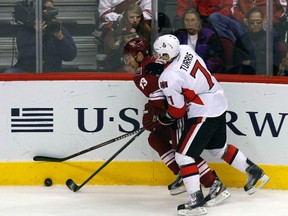 Ottawa Senators' Kyle Turris (7) battles for the puck with former teammate, Phoenix Coyotes' Ray Whitney (13), in the first period of their NHL game in Glendale, Arizona January 24, 2012. (REUTERS/Joshua Lott)