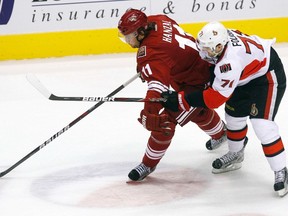 Ottawa Senators' Nick Foligno (71) battles for the puck with Phoenix Coyotes' Martin Hanzal in the first period of their NHL game in Glendale, Arizona January 24, 2012. REUTERS/Joshua Lott