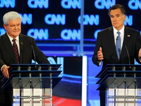 Republican presidential candidate former Speaker of the House Newt Gingrich (L) listens as Massachusetts Governor Mitt Romney makes a point during the Republican presidential candidates debate in Jacksonville, Florida January 26, 2012.  (REUTERS/Scott Audette)