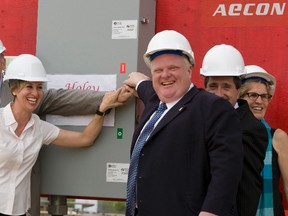 From left, Peter Kent, federal minister of the environment, TTC chairman Karen Stintz, Mayor Rob Ford, York Region Chairman and CEO Bill Fisch, and Ontario Transportation Minister Kathleen Wynne pull the power switch on the Toronto-York Spadina Subway Extension at Downsview Park. (Dave Thomas/Toronto Sun files)