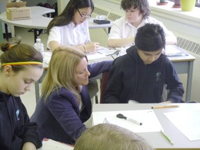 DSBN Academy teacher Mrs. Stephanie Minor with students Lindsey Hills, left, and Zainoona (Lilly) Omar. In the background is Olivia Bouaban, left, and Sean Connell.
MOIRA MACDONALD/TORONTO SUN