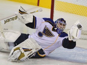 St Louis Blues goalie Brian Elliott makes a glove save against the Calgary Flames at the Scotiabank Saddledome in Calgary on Oct. 28. (JIM WELLS/QMI AGENCY)