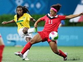 Desiree Rose Marie Scott (R) of Canada tries to block Miraildes Mota of Brazil in their women's soccer gold medal match at the Pan American Games in Guadalajara October 27, 2011.  REUTERS/Henry Romero