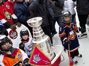 Young children from the Nepean Minor Hockey Association transport NHL trophies down the Rideau Canal Skateway to the Ottawa Convention Centre to kick-off NHL All-Star festivities in the capital. Thursday January 26,2012. (ERROL MCGIHON/OTTAWA SUN)