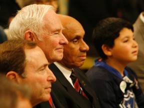Governor General David Johnson sits with NHL commissioner Gary Bettman, left, and former Boston Bruin Willie O'Ree at a Rideau Hall event to mark the launch of HEROS in Ottawa — a program which helps under-privileged kids get involved in hockey and improve their grades. (DOUG HEMPSTEAD/Ottawa Sun)