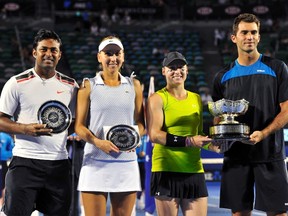 Bethanie Mattek-Sands of the U.S. and Horia Tecau of Romania (R) pose with their trophy next to Elena Vesnina of Russia (2nd L) and Leander Paes of India (L) after their mixed doubles final match at the Australian Open tennis tournament in Melbourne January 29, 2012. REUTERS/Toby Melville