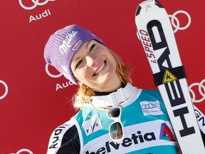 First placed Maria Hoefl-Riesch of Germany smiles on the podium after the women's Alpine skiing World Cup super combined race in the Swiss mountain resort of St. Moritz January 29, 2012. REUTERS/Pascal Lauener