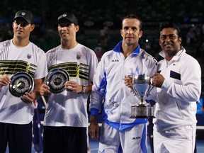Leander Paes of India (R) and Radek Stepanek of Czech Republic pose with their trophy next to Bob and Mike Bryan of the U.S. after their men's doubles final match at the Australian Open tennis tournament in Melbourne January 28, 2012.     REUTERS/Darren Whiteside