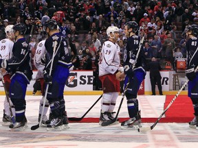 Members of Team Alfredsson and Team Chara shake hands following the all-star game at Scotiabank Place on Sunday. (Tony Caldwell, Ottawa Sun)