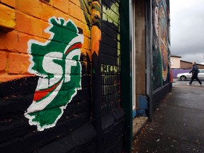Sinn Fein graffitti is seen painted on the wall of a shop on the Beechmount Parade near the Falls road in West Belfast October 10, 2011.  REUTERS/Cathal McNaughton