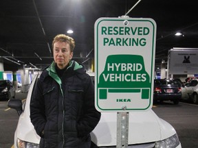 Somerset Coun. Diane Holmes stands by her hybrid car in the Ikea parking lot Dec. 16, 2011. (Tony Caldwell/Ottawa Sun)
