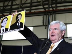 U.S. Republican presidential candidate and former Speaker of the House Newt Gingrich holds a photo given to him from the audience during a rally in Tampa, Florida January 30, 2012. (REUTERS/Shannon Stapleton)