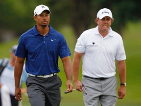Tiger Woods (left) and Phil Mickelson walk up to the second green during the first round of the WGC-Cadillac Championship at the TPC Blue Monster in Doral, Fla., March 10, 2011. (HANS DERYK/Reuters)