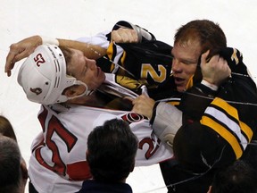 Boston Bruins' Shawn Thornton (R) fights with Ottawa Senators' Chris Neil during the first period of their NHL hockey game at TD Garden in Boston January 31, 2012. REUTERS/Jessica Rinaldi