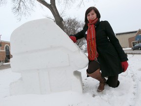 Festival du Voyageur director of marketing and communications Emili Bellefleur stands with one of the festival's snow sculptures along Provencher Boulevard on Wednesday, Feb. 1, 2012. (Jason Halstead, Winnipeg Sun)