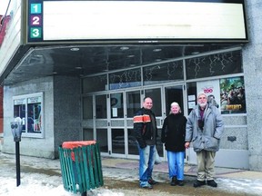 Theatre manager Jan Stepniak, at far right, stands in front of the Premier Cinemas building in Smiths Falls, which is about to close despite a petition circulating to keep it open.