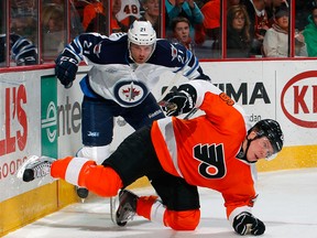Jets coach Claude Noel likes what he sees in callup Aaron Gagnon, seen knocking down Philadelphia's Eric Gustafsson during their NHL tilt on Jan. 31, 2012. (PAUL BERESWILL/AFP-GETTY IMAGES)
