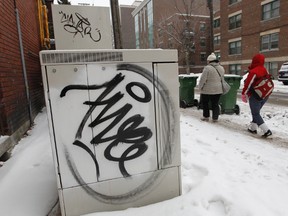 Graffiti like this tag on Cooper St. costs taxpayers $1.6 million a year to clean up. (Tony Caldwell/Ottawa Sun)