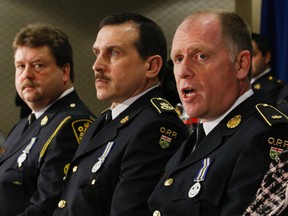 Det. Staff-Sgt. Frank Goldschmidt, Acting OPP Commissioner Scott Tod and Insp. Scott Naylor talk to media Thursday about the child-porn busts carried out across Ontario. (Craig Robertson/Toronto Sun)