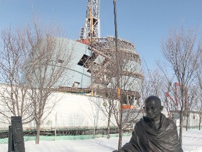 A statue of Mahatma Ghandi, who was murdered this month in 1948 after seeking non violent reform in India, in front of the Canadian Museum for Human Rights at The Forks in Winnipeg. (CHRIS PROCAYLO/Winnipeg Sun)