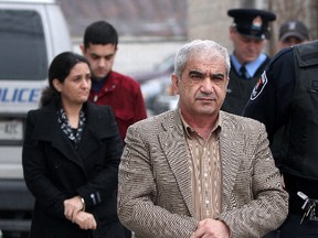 Mohammad Shafia, left, wife Tooba Mohammad Yahya and their son Hamed, rear, are pictured outside the Frontenac County Court house in Kingston, Ont., Jan. 26, 2011. (QMI Agency)