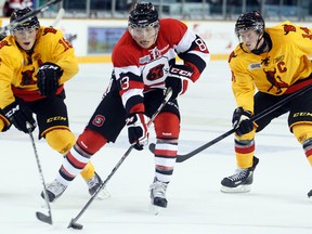 67's defenceman Cody Ceci (centre) stickhandles between Belleville's Brendan Gaunce (left) and Luke Judson in OHL action earlier this season. Ceci, ranked 16th among North American skaters by Central Scouting, will miss this weekend's games with a pinched nerve. (Darren Brown/Ottawa Sun)