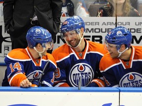 Edmonton Oilers' Sam Gagner (C) talks with linemates Jordan Eberle (L) and Taylor Hall on the bench after scoring his fourth goal against the Chicago Blackhawks during the third period of their NHL hockey game in Edmonton February 2, 2012. He went on to score eight points. (REUTERS/Dan Riedlhuber)