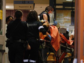 A man is brought into St. Michael’s Hospital emergency after being shot by police Friday in the Coxwell-Danforth area. (Craig Robertson/Toronto Sun)