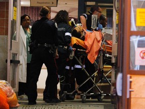 A man is brought into St. Michael’s Hospital emergency after being shot by Toronto police. (Craig Robertson/QMI Agency)