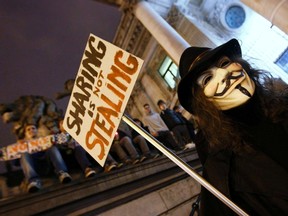 A protester wearing a Guy Fawkes mask, symbolic of the hacktivist group "Anonymous", takes part in a protest in central Brussels January 28, 2012. (REUTERS/Yves Herman)