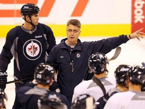 Winnipeg Jets head coach Claude Noel (centre) gives instructions to players during practice back in October of 2011. (BRIAN DONOGH/WINNIPEG SUN)