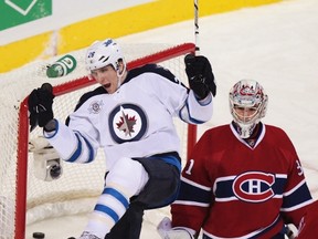 Blake Wheeler, seen here celebrating a goal against Carey Price and the Montreal Canadiens, said he is happy to be a Winnipeg Jet. (CHRISTINE MUSCHI/REUTERS Files)