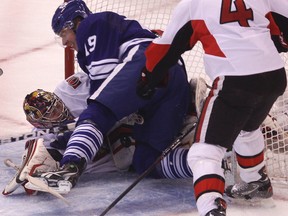 Leafs forward Joffrey Lupul slams into Senators goaltender Craig Anderson at Scotiabank Place Saturday night. (Tony Caldwell/Ottawa Sun)