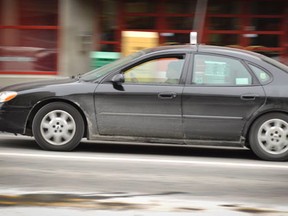 A taxi cab drives through Ottawa.  (Matthew Usherwood/ Ottawa Sun)