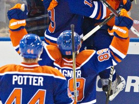 Edmonton Oilers players mob Jordan Eberle after he scored a last-minute, game-tying goal during Saturday's 5-4 shootout win over the Detroit Red Wings.