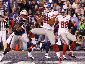 Giants wide receiver Victor Cruz scores a touchdown in front of Patriots safety James Ihedigbo during Super Bowl XLVI at Lucas Oil Field in Indianapolis, Ind., Feb. 5, 2012. (MIKE SEGAR/Reuters)