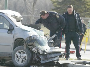 April 30/2008-Police investigate a serious crash on north Main Street near Templeton Avenue involving a front end loader and two cars. One critical injury. (Winnipeg SUn FILE PHOTO)