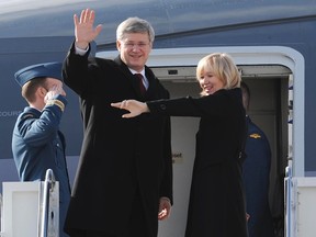 Prime Minister Stephen Harper and his wife Laureen wave as they board CF01 en route to China, in Ottawa, Feb 6, 2012. (ANDRE FORGET/QMI AGENCY)