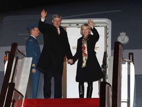 Canada’s Prime Minister Stephen Harper and his wife Laureen wave while disembarking their plane after arriving in Beijing February 7, 2012. REUTERS/Chris Wattie