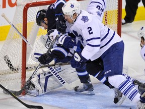 Maple Leafs defenceman Luke Schenn pushes Jets forward Aaron Gagnon into goaltender Jonas Gustavsson at the MTA Centre in Winnipeg, Man., Feb. 7, 2012. (FRED GREENSLADE/Reuters)