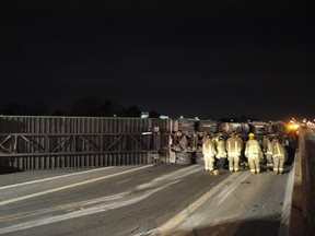 A tractor-trailer lies on its side on the QEW at Winston Churchill Blvd. in Mississauga Wednesday morning following a collision. (DAVID RITCHIE photo)