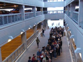 Volunteers line up at the Winnipeg airport. More than 64,000 newcomers arrived in the province from 2005-2010, according to new census data.