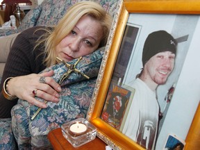 Linda Beland poses with a photo of her murdered son Douglas at her house in Ottawa Wednesday.  Linda has decided not to have a vigil for her son this year.   Tony Caldwell/Ottawa Sun
