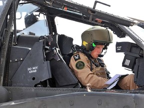 A handout image obtained on February 8, 2012, in London, from Britain's Ministry of Defence shows EX Crimson Eagle Capt Wales (also known as Britain's Prince Harry) preparing to go out on an Apache helicopter training mission at the Naval Air Facility (NAF) El Centro in California. Prince Harry has become a fully operational Apache Attack Helicopter Pilot after successfully completing 18 months of intensive training. AFP PHOTO/SGT RUSS NOLAN RLC/BRITISH MOD/HANDOUT